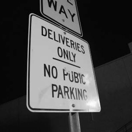 Photo of a sign that reads Deliveries Only. No Pubic Parking